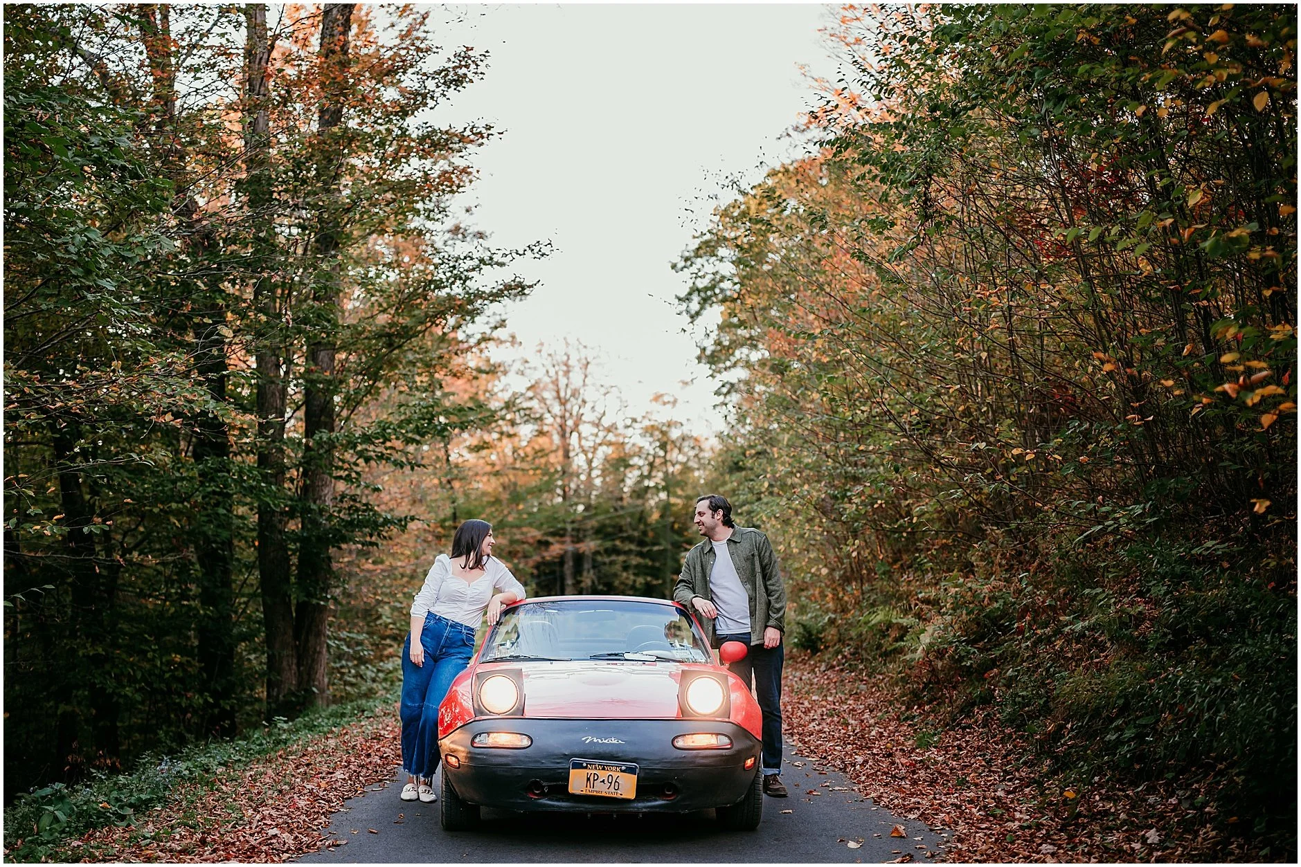 Engagement session featuring classic red car and fall colors