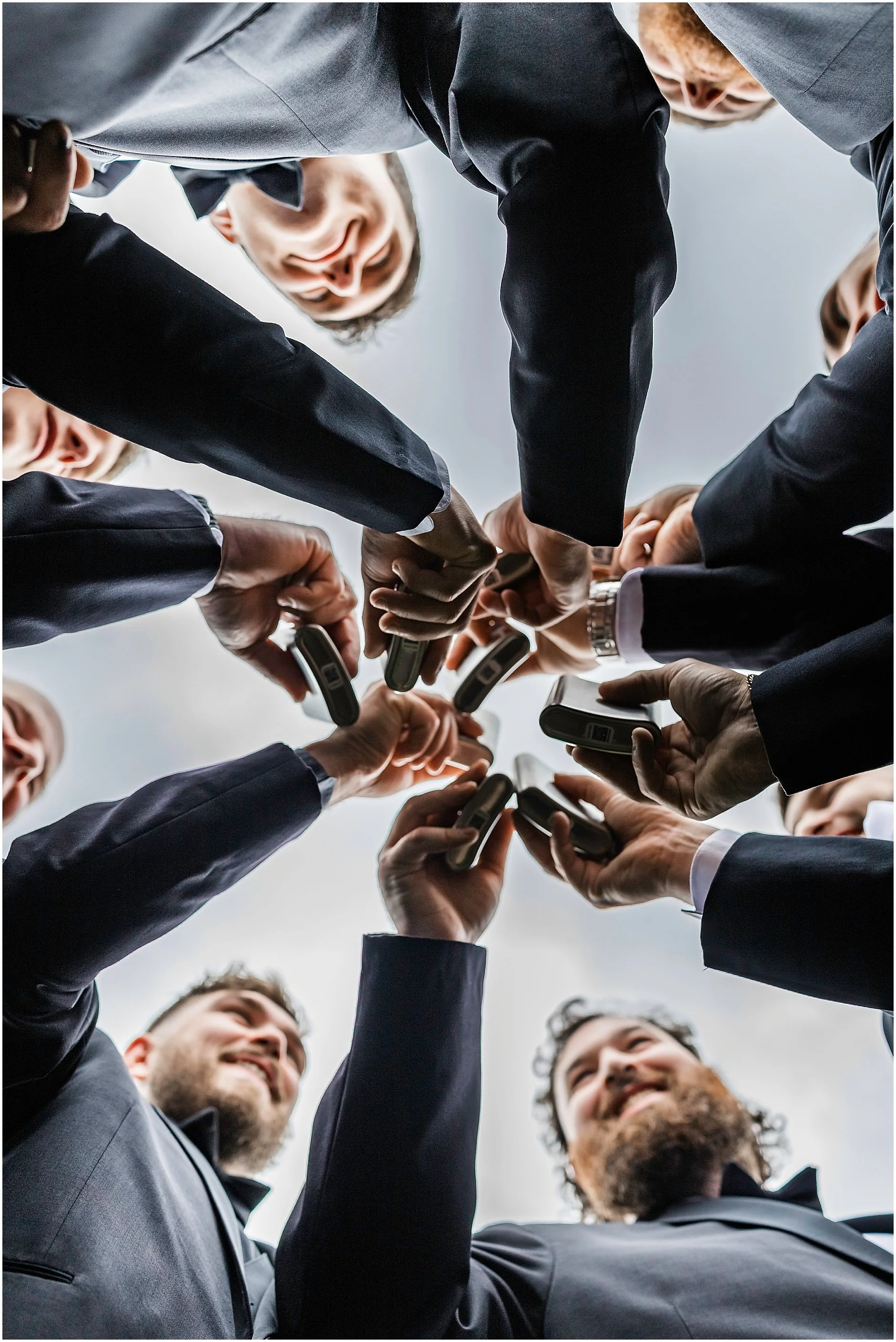 Shot from below of the groomsman toasting to the groom before the wedding ceremony at a venue in the Catskills.