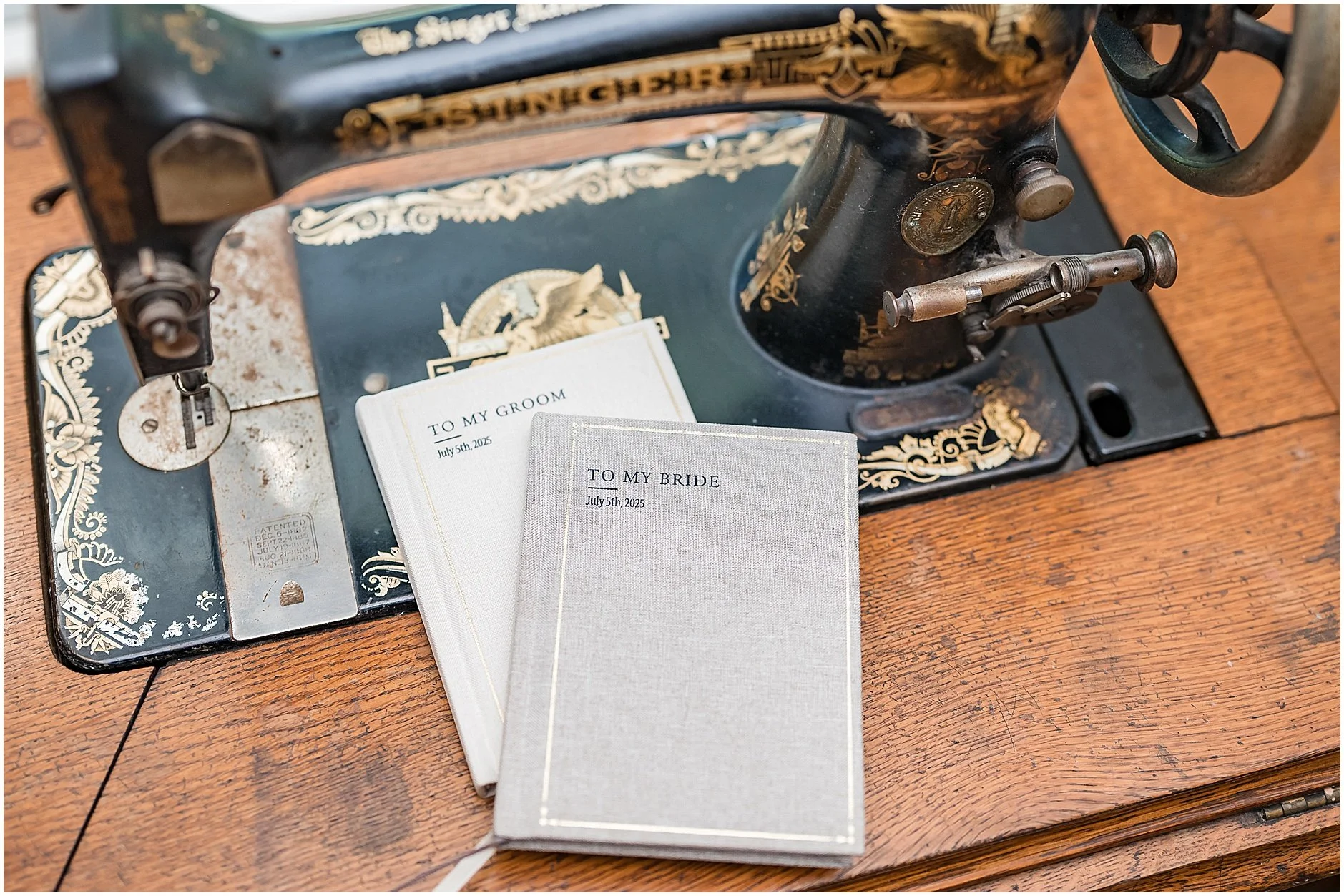 Vow books under a vintage sewing machine