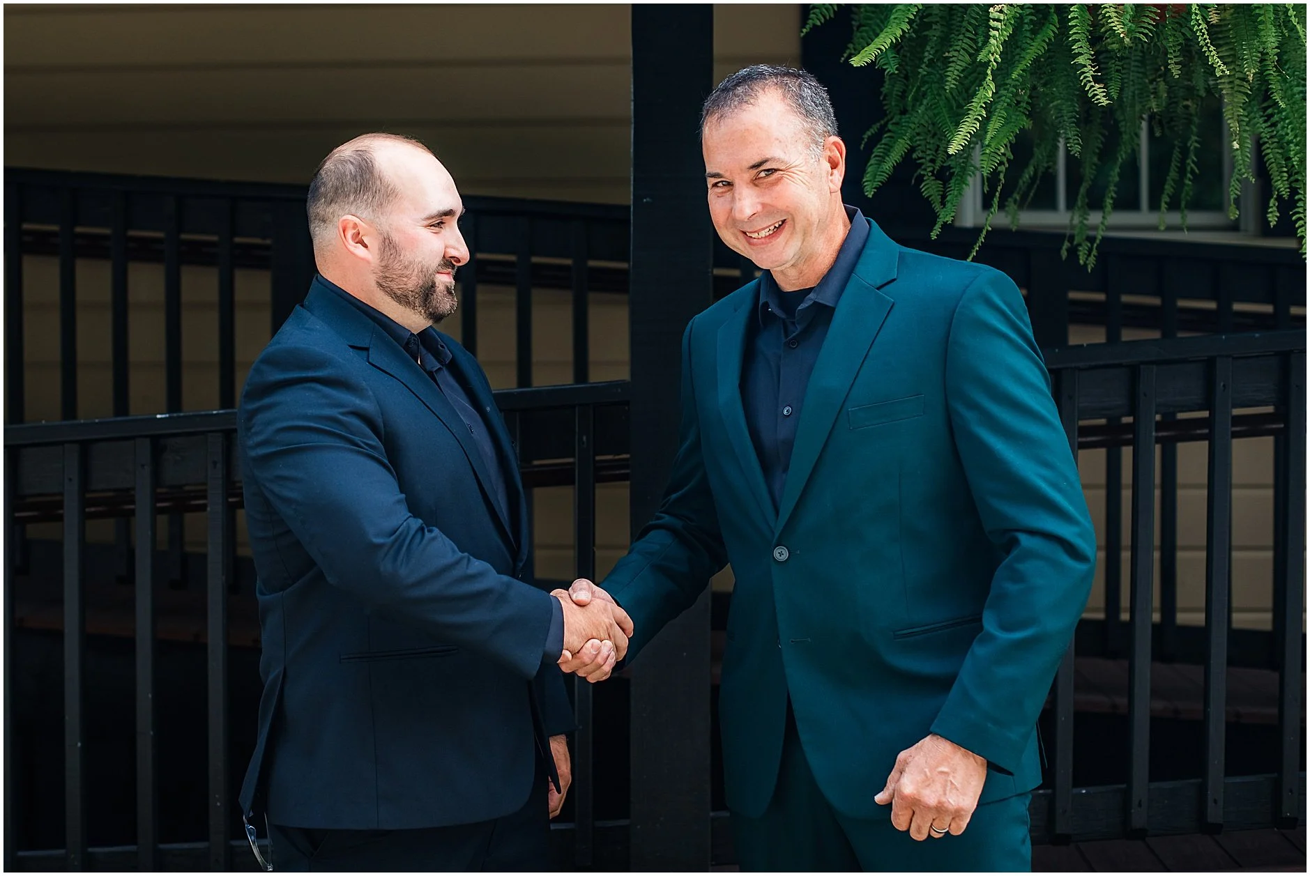 Groom shaking hands with one of his groomsmen