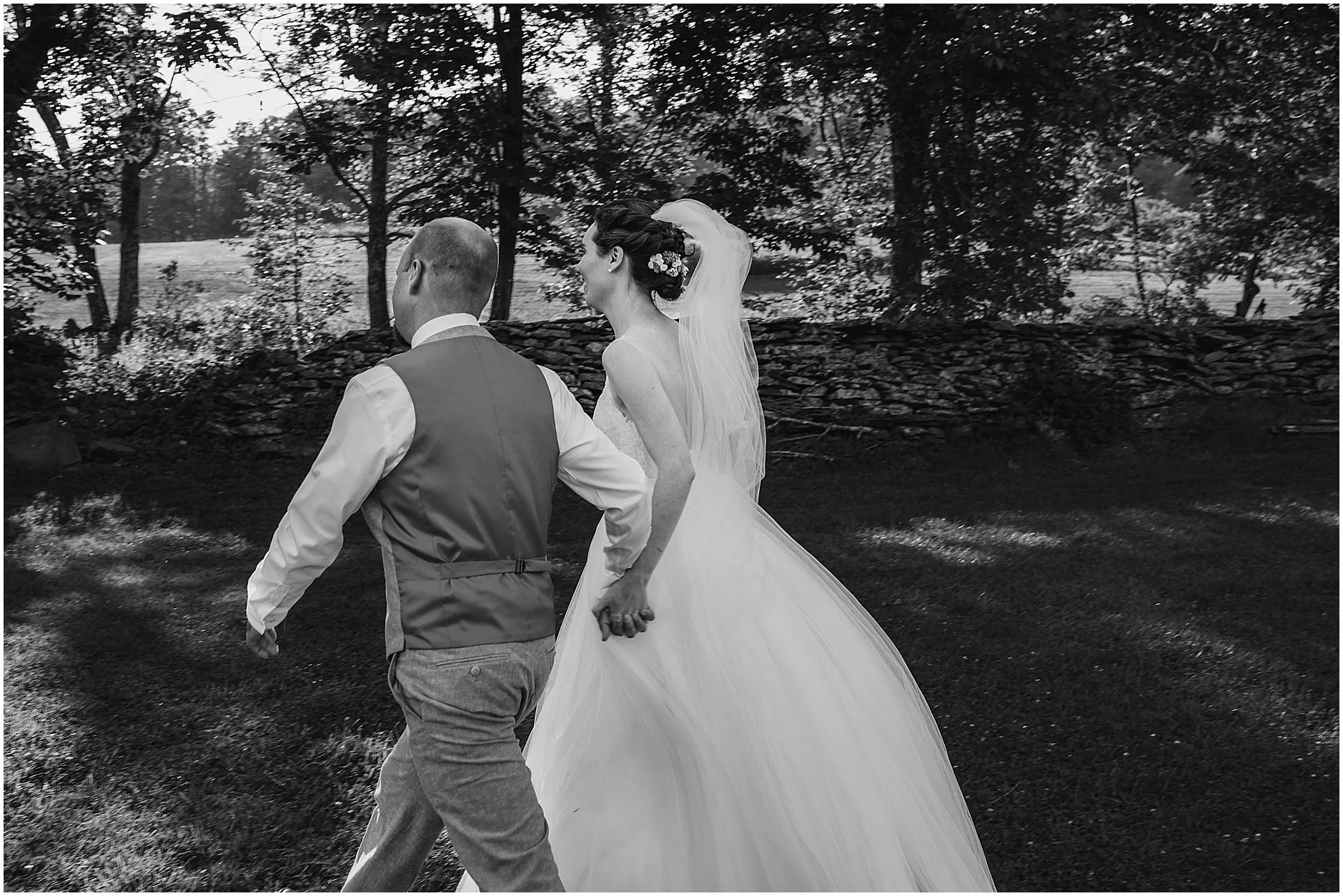 Candid image of the bride and groom running out of their ceremony