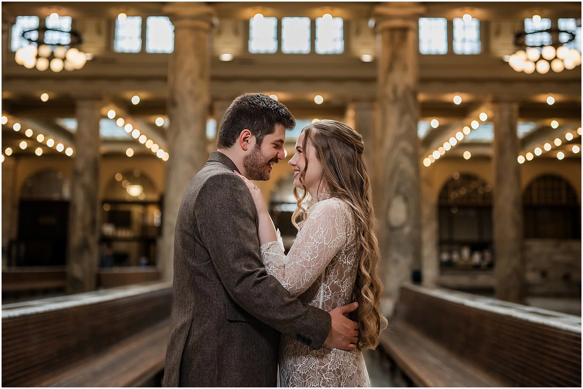 Artistic engagement portraits of Alexis and Alec at a historic train station, incorporating the station’s structure and architectural details into the photographs.