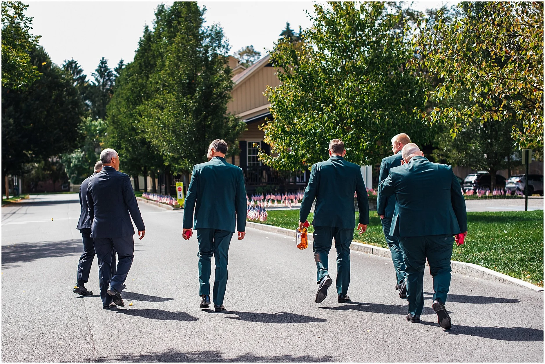 Groom and groomsman walking to their Airbnb in Cooperstown New York ahead of the wedding ceremony at The Rosemary at Spano Lake