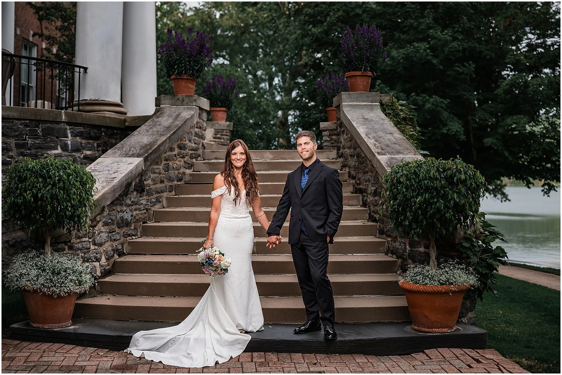 Couple walking through scenic grounds during their intimate elopement in Upstate New York.