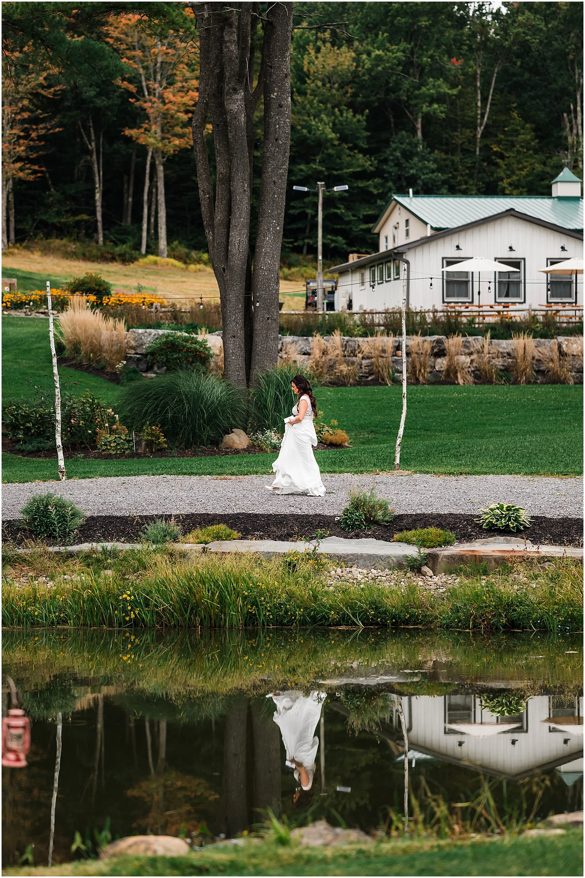Bride walking around the lake at The Rosemary at Spano Lake to meet her groom for their first look