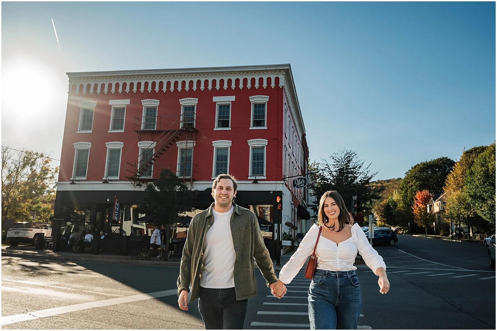 Timeless engagement portrait with historic Cooperstown architecture