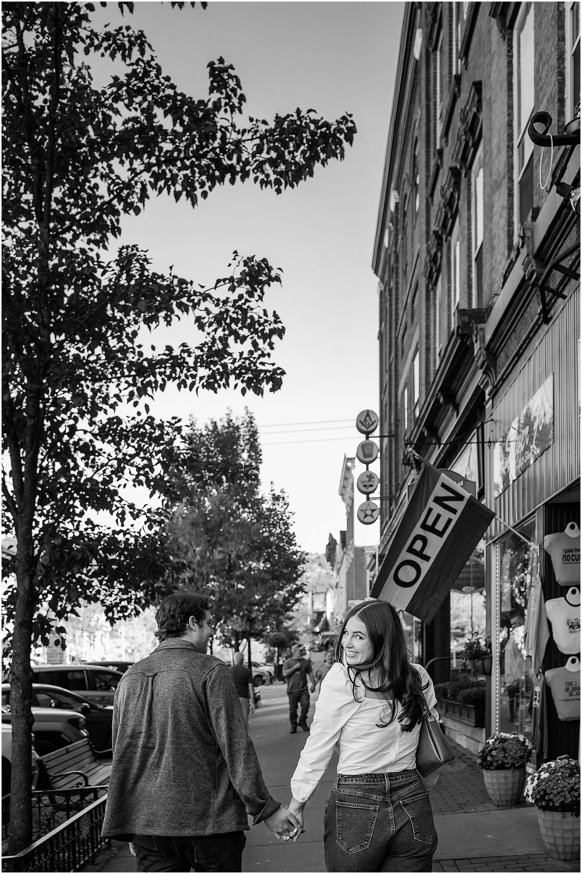 Candid moment strolling Main Street during Cooperstown NY engagement session
