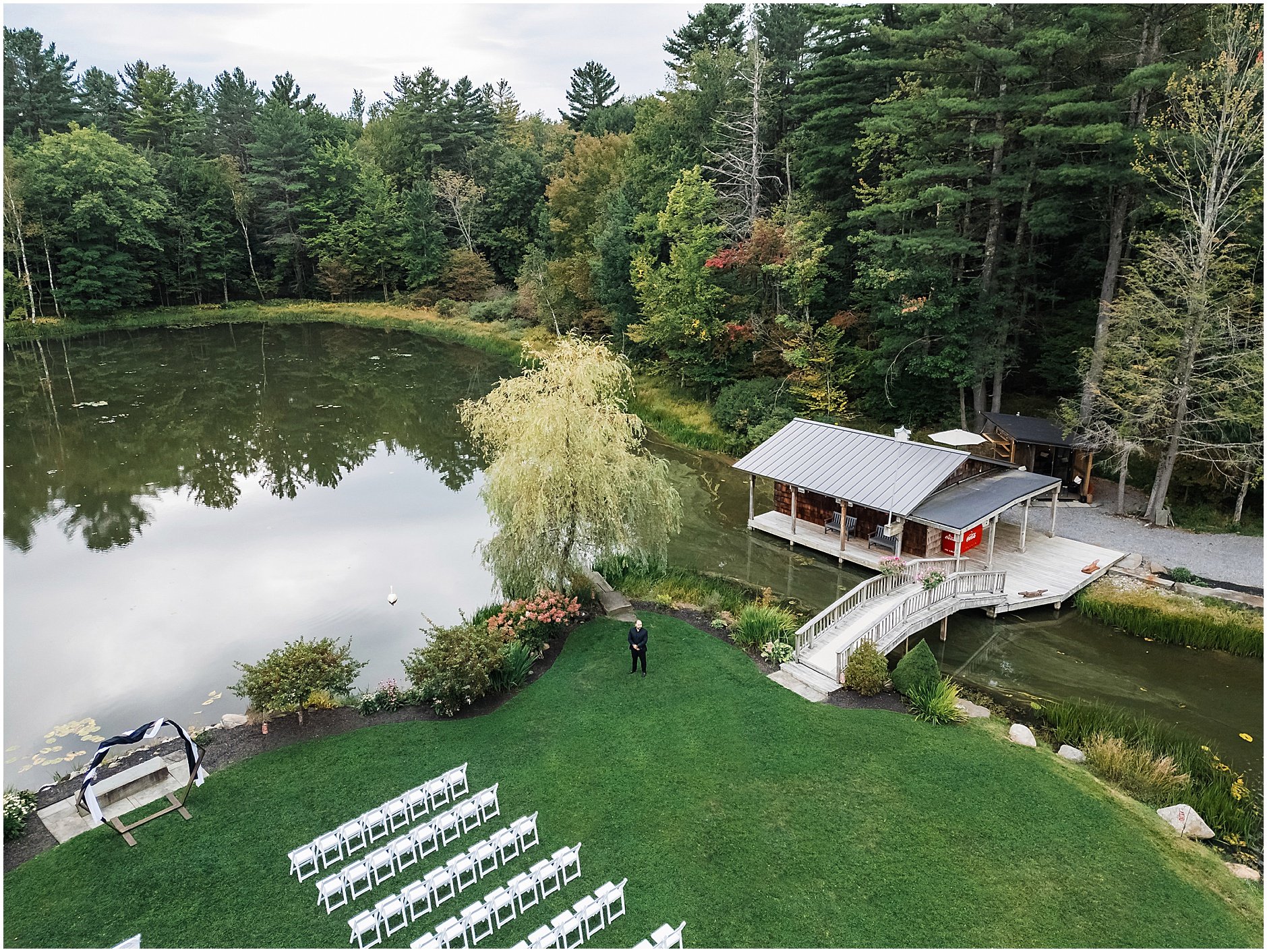 Aerial image of the groom awaiting his bride for their first look by the lake at The Rosemary at Spano Lake