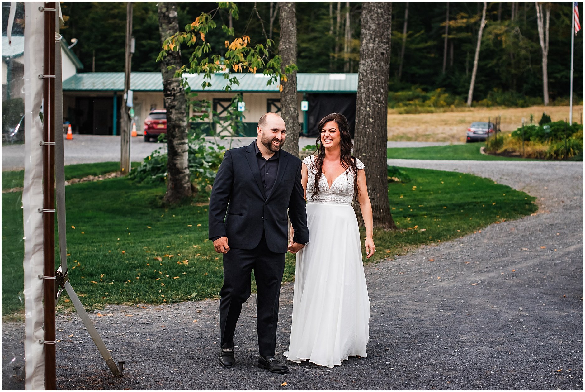 Bride and groom sharing a laugh as they enter their tented reception in Cooperstown NY
