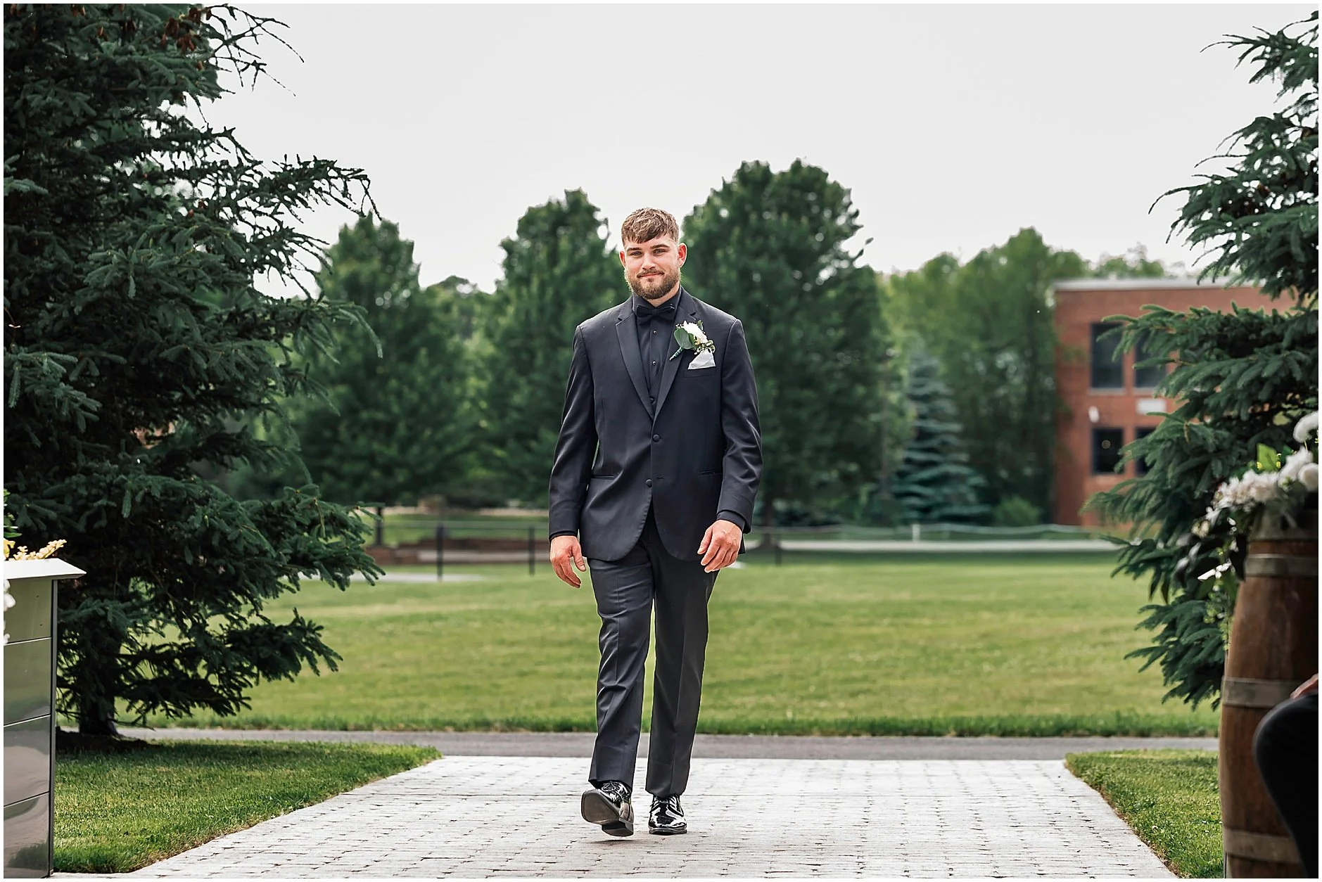 The groom walking down the aisle at a spring wedding in New York.