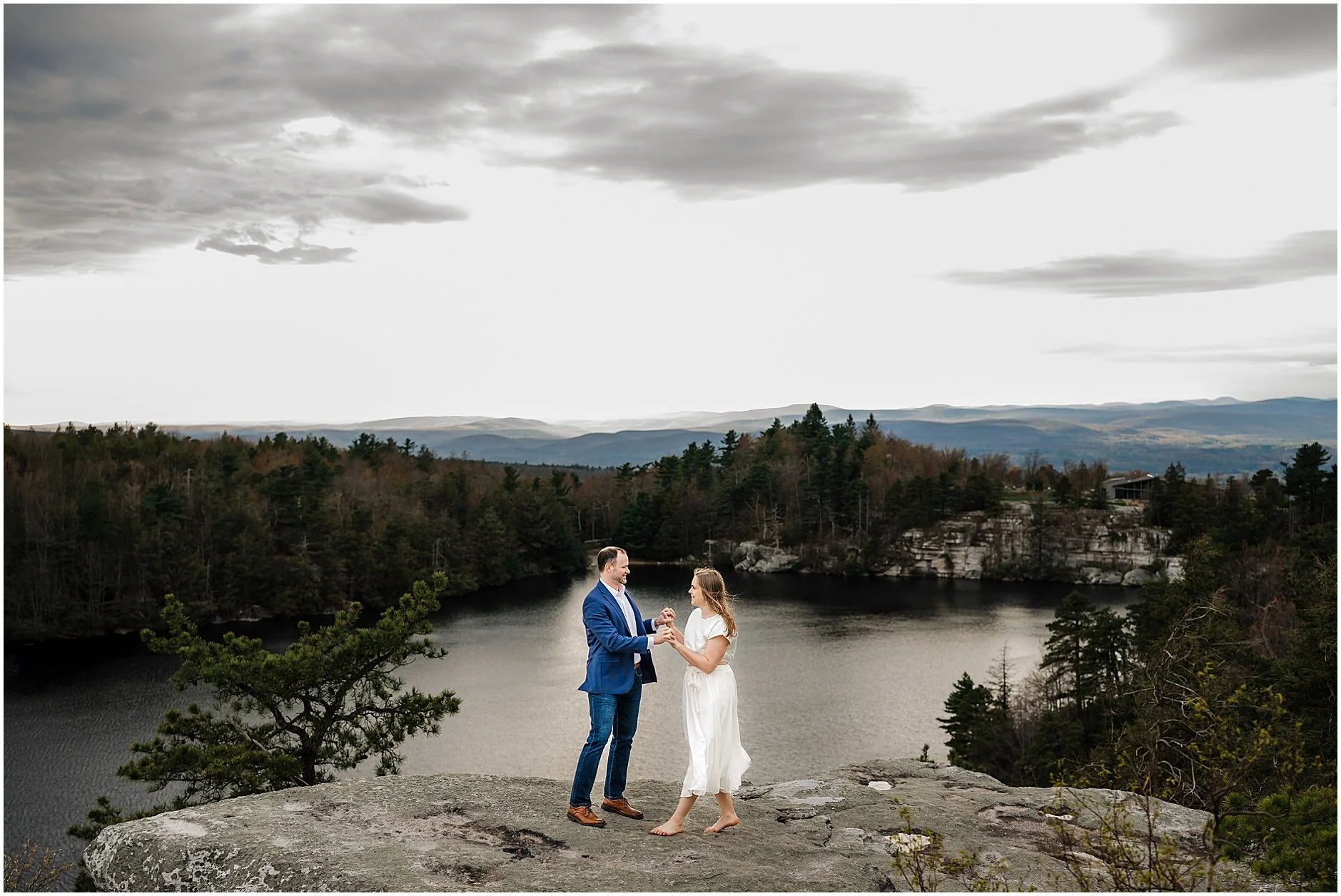 Couple embracing with Hudson Valley mountain views during engagement photos