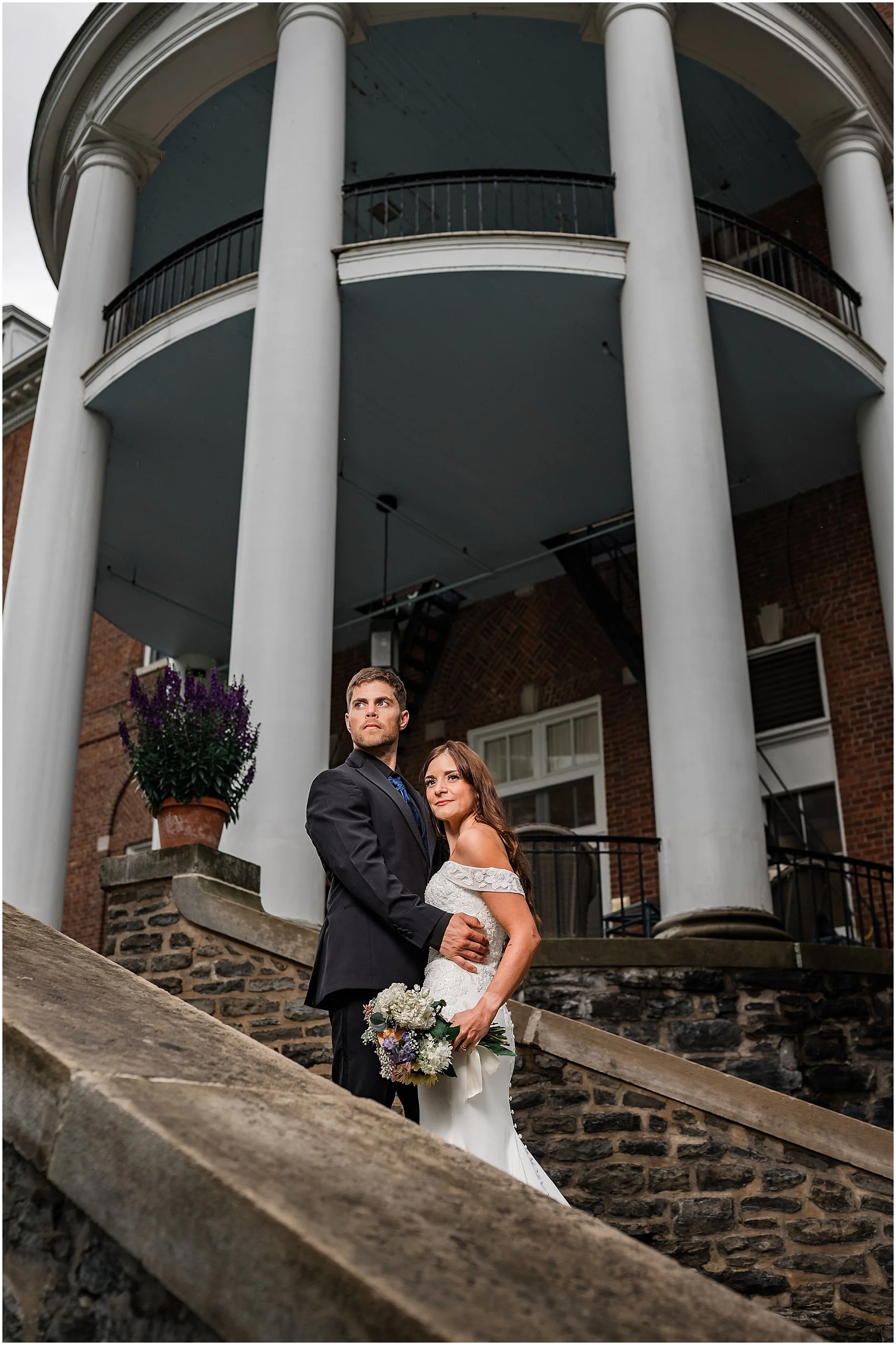 Couple embracing outside a historic Cooperstown, New York wedding venue.