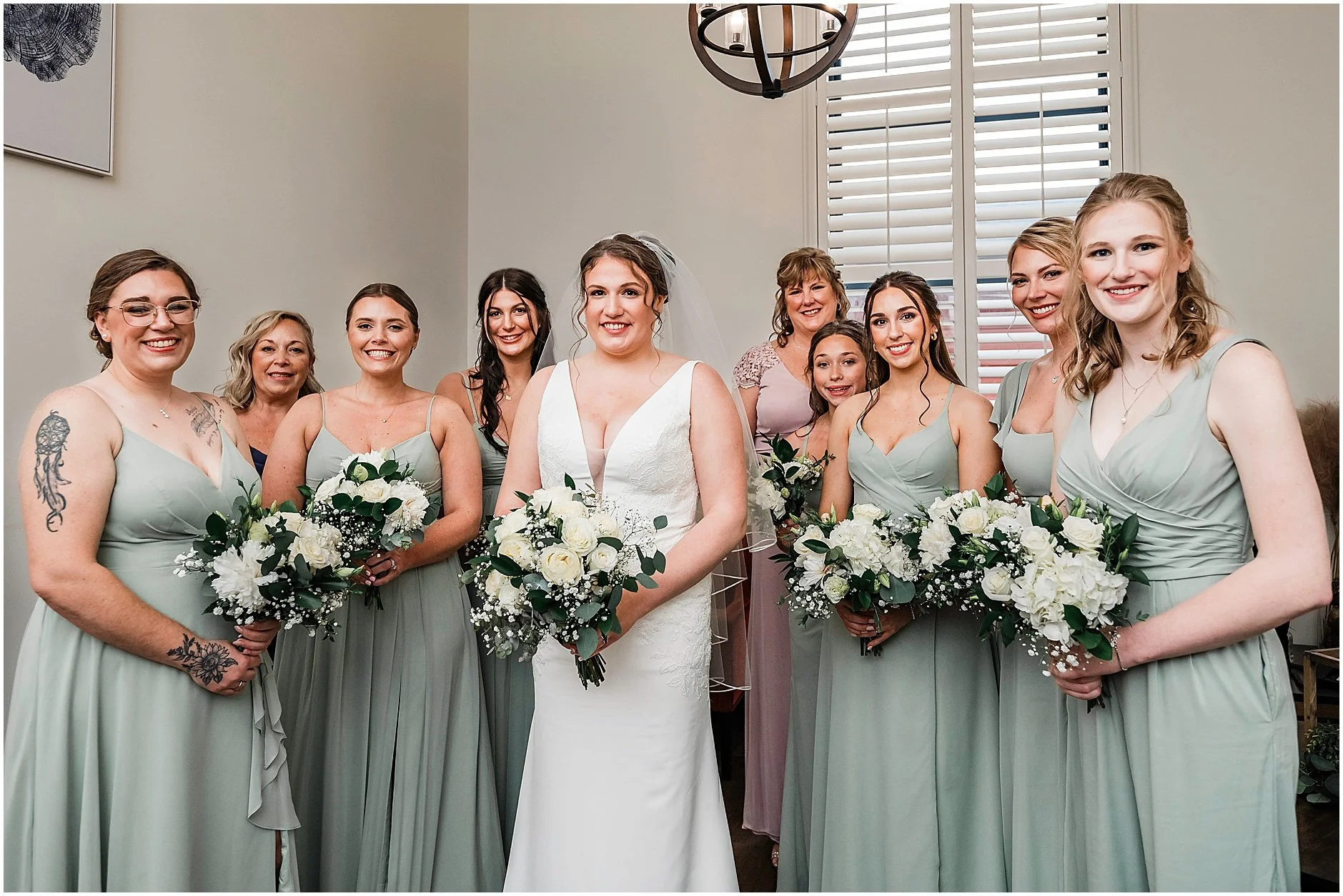 Bridesmaids surrounding the bride as she gets ready to walk down the aisle at her spring wedding in New York.