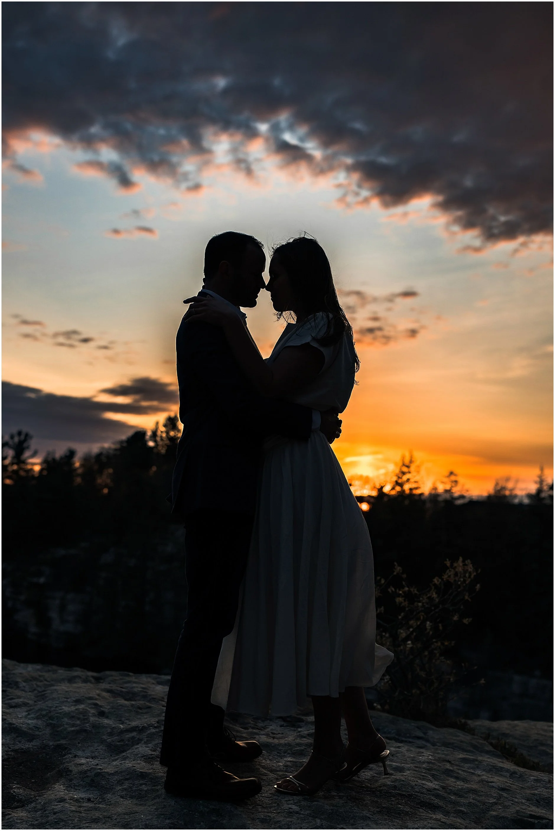Couple silhouetted at sunset during Hudson Valley engagement session