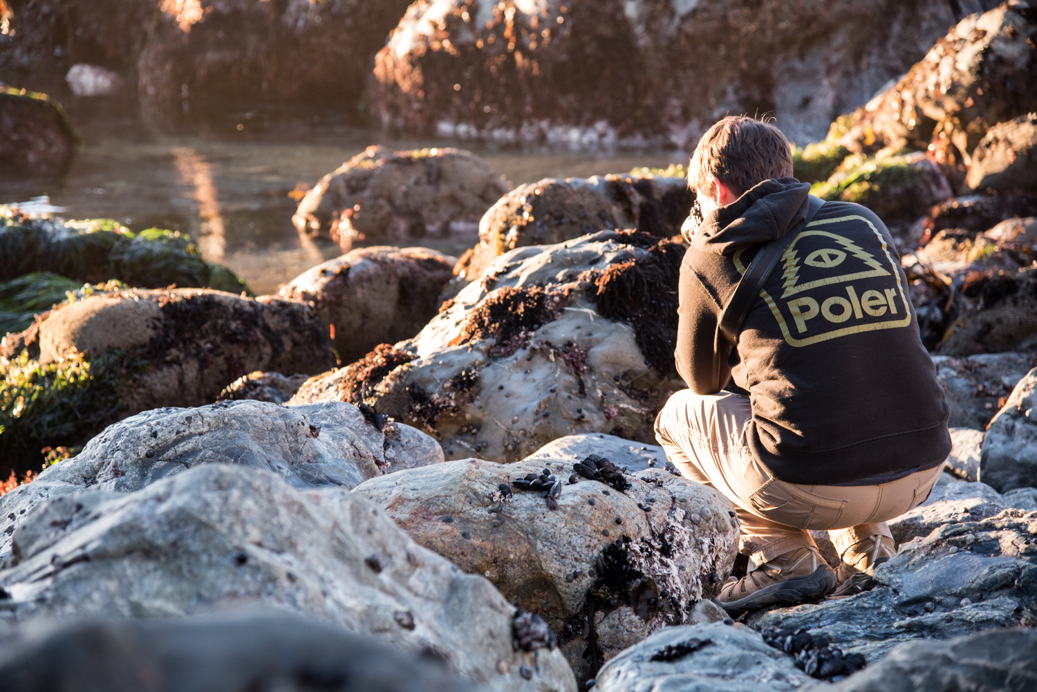 Kim stays warm in her Poler shirt, while photoing from the slippery rocks.