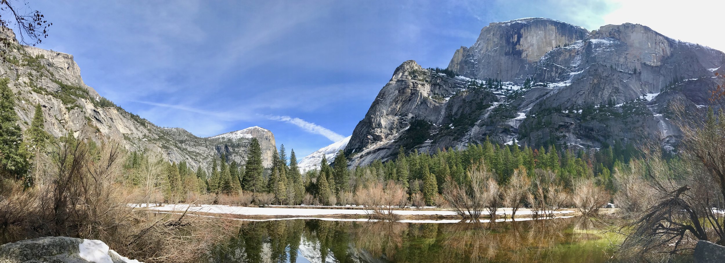From the left: Basket Dome, Mt. Watkins, snowy Clouds Rest in the background, Ahwiyah Peak, and Half Dome. (Thanks to @yosemitenps on Twitter for helping with the identification of these landmarks!)