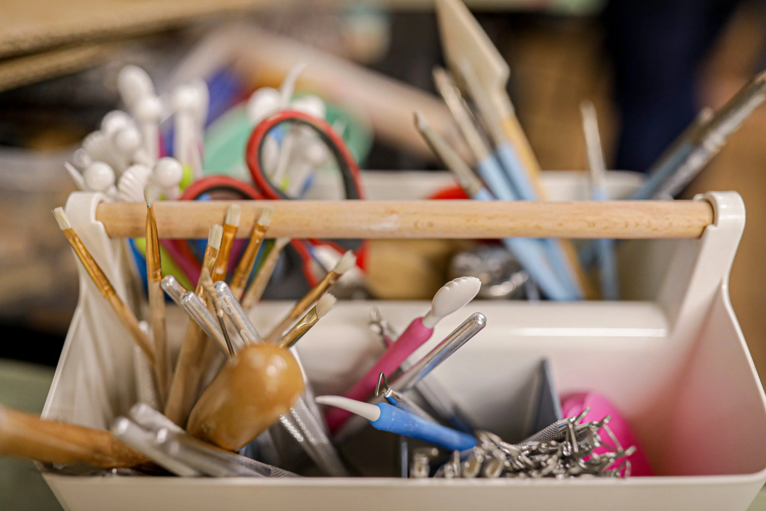 Handbuilding pottery tools in a divided tray.