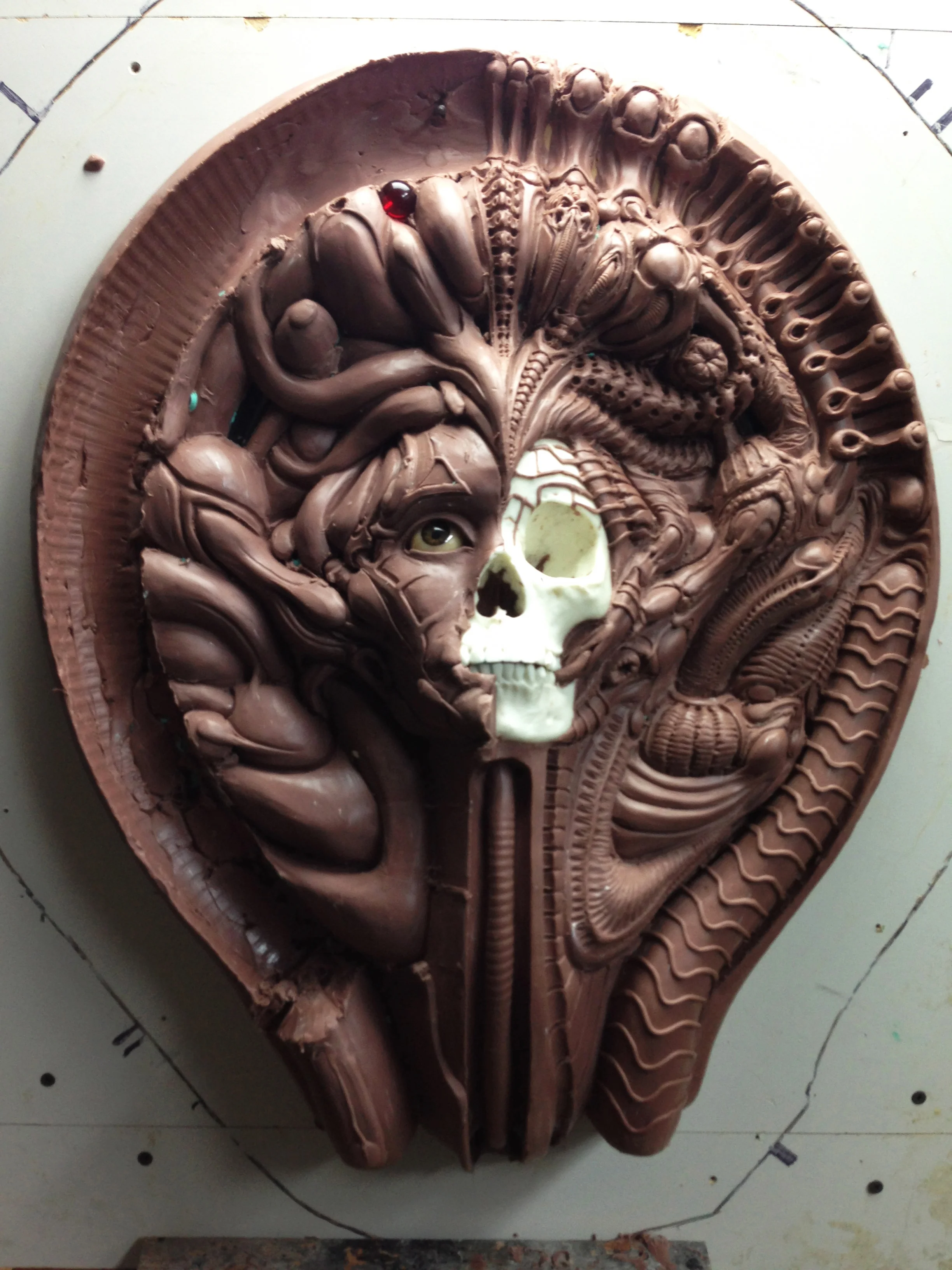 Now that “Bliss is finished it was time to start the its counterpart. “Behind the Veil” which represents death of the physical body. I slowly peeled away the clay revealing the female anatomical skull underneath and began adding details to the existing shapes from bliss.