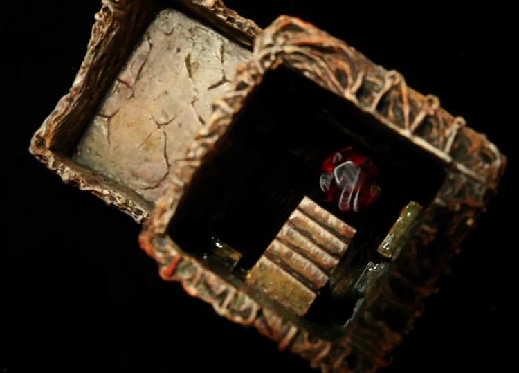 Top view of tower showing a 12 sided dice bouncing off of first set of internal stairs