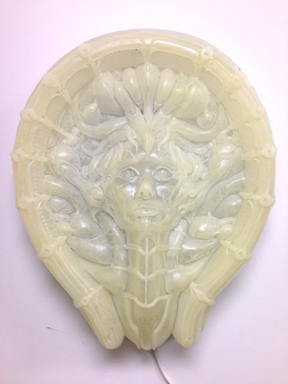 Here was have the first casting made in a semi translucent resin. The mold is rather large so in order to get all the detail without filling the mold solid, I have to rotate the piece with small batched of liquid resin. It usually sets in 2-3 min. We call it driving the bus. It looks like I’m turning a massive buss wheel as I rotate the mold. A rather cumbersome and tedious process, but the results are worth it.