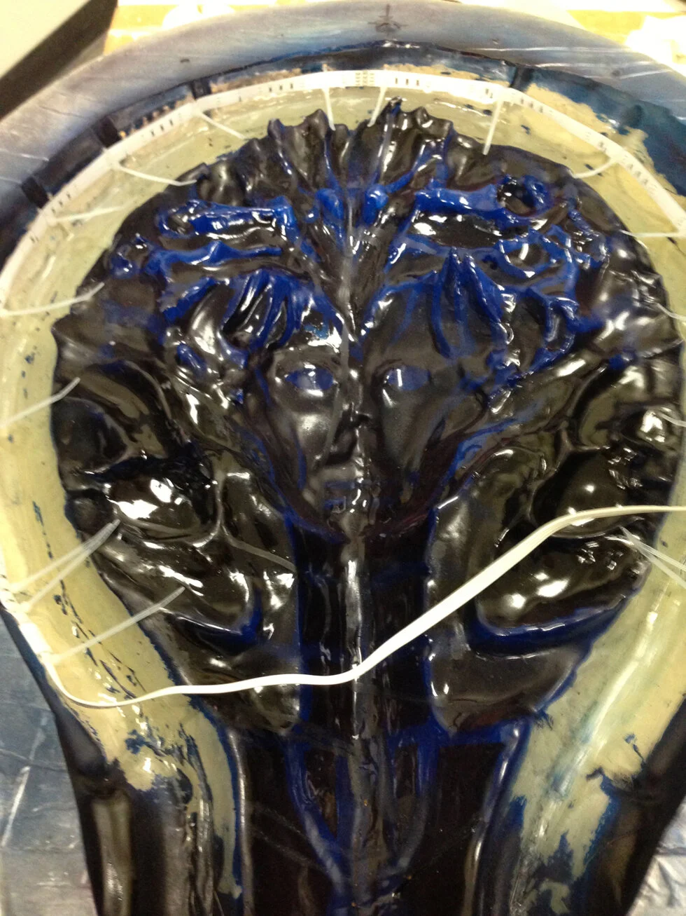 After the masking latex areas dried I spray painted the entire inside surface black. Once it dried, I carefully pulled off the latex exposing the unpainted areas and liberally coated them in a translucent blue paint. Maybe 2 or three coats. The image above also shows the outer rim I lined with an additional 40” LED color changing strip which connect to that control box on the back panel.