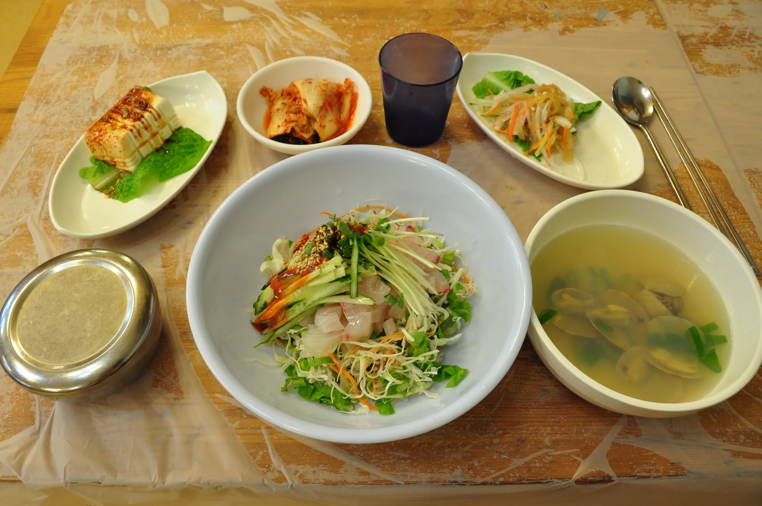 Kimchi, endless side dishes, a silver bowl of rice - this is a typical Korean meal. But save the (warm) glass of water until you're done eating. It's better for digestion. 