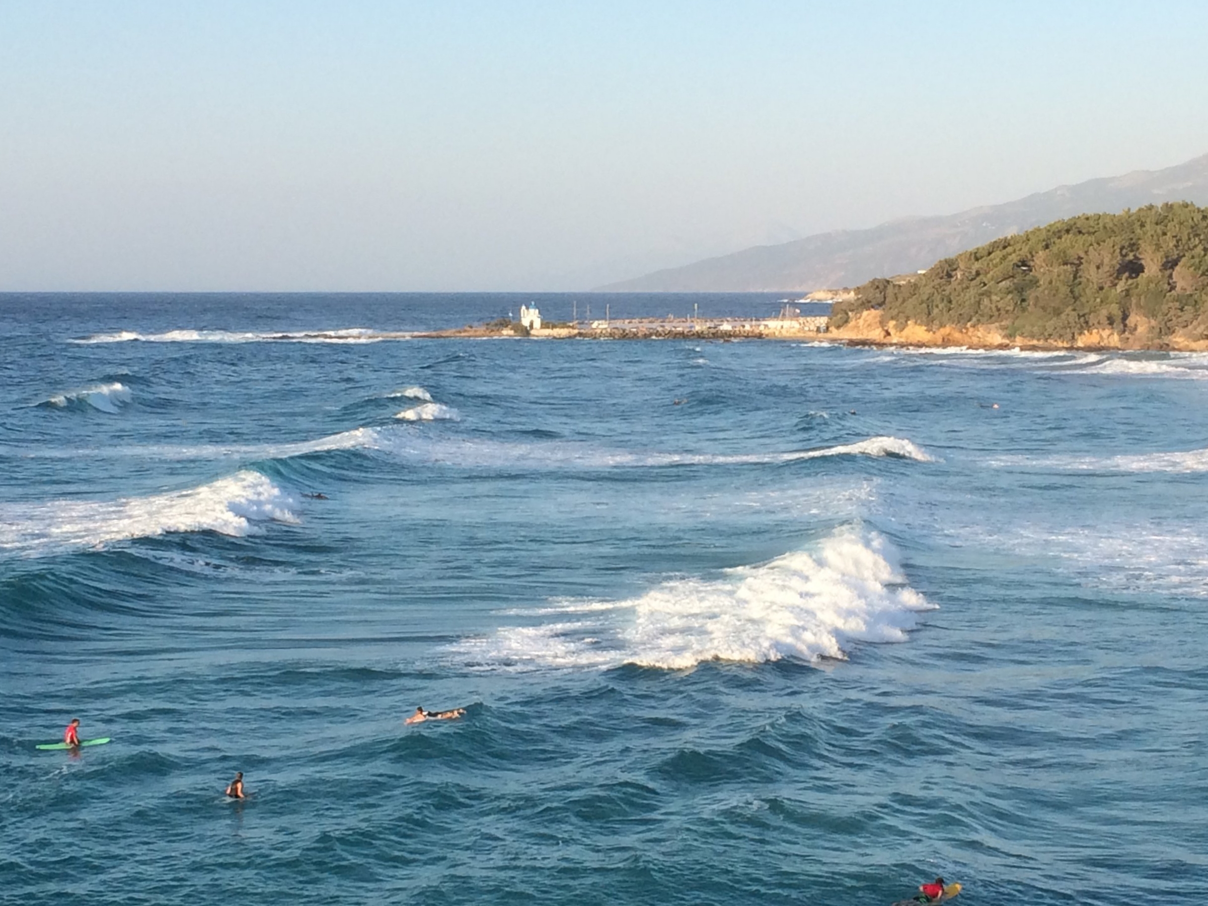 Surfers waiting to catch a wave at Mesakti Beach