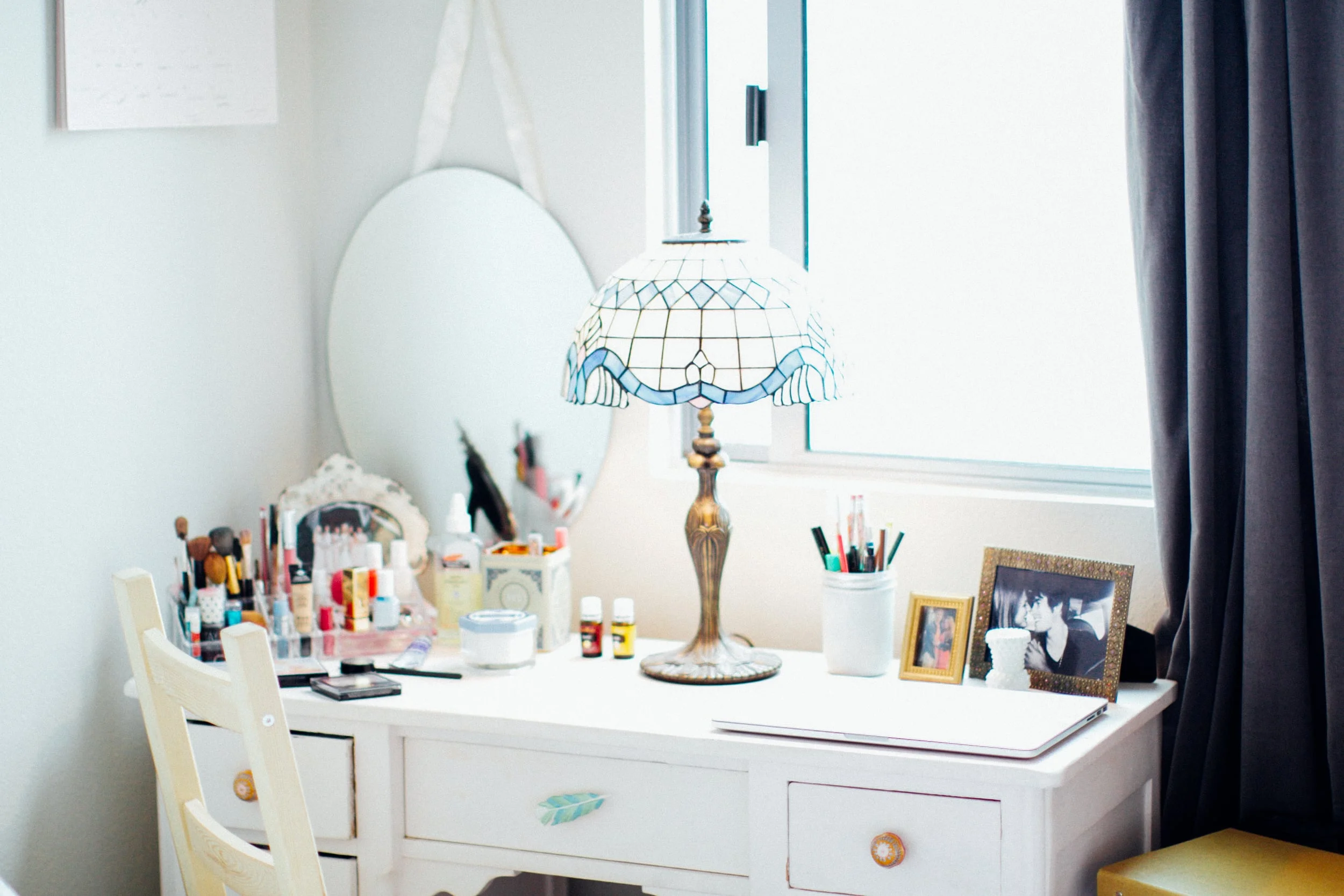my pale pink desk (built in the 1920's and found at an antique store near my parent's mountain home for $30!) I love this little space and do alot of work here as well as use the left side and drawer as a vanity for putting on my makeup -- can't beat the lighting from the wide window and the dreamy ocean view. 