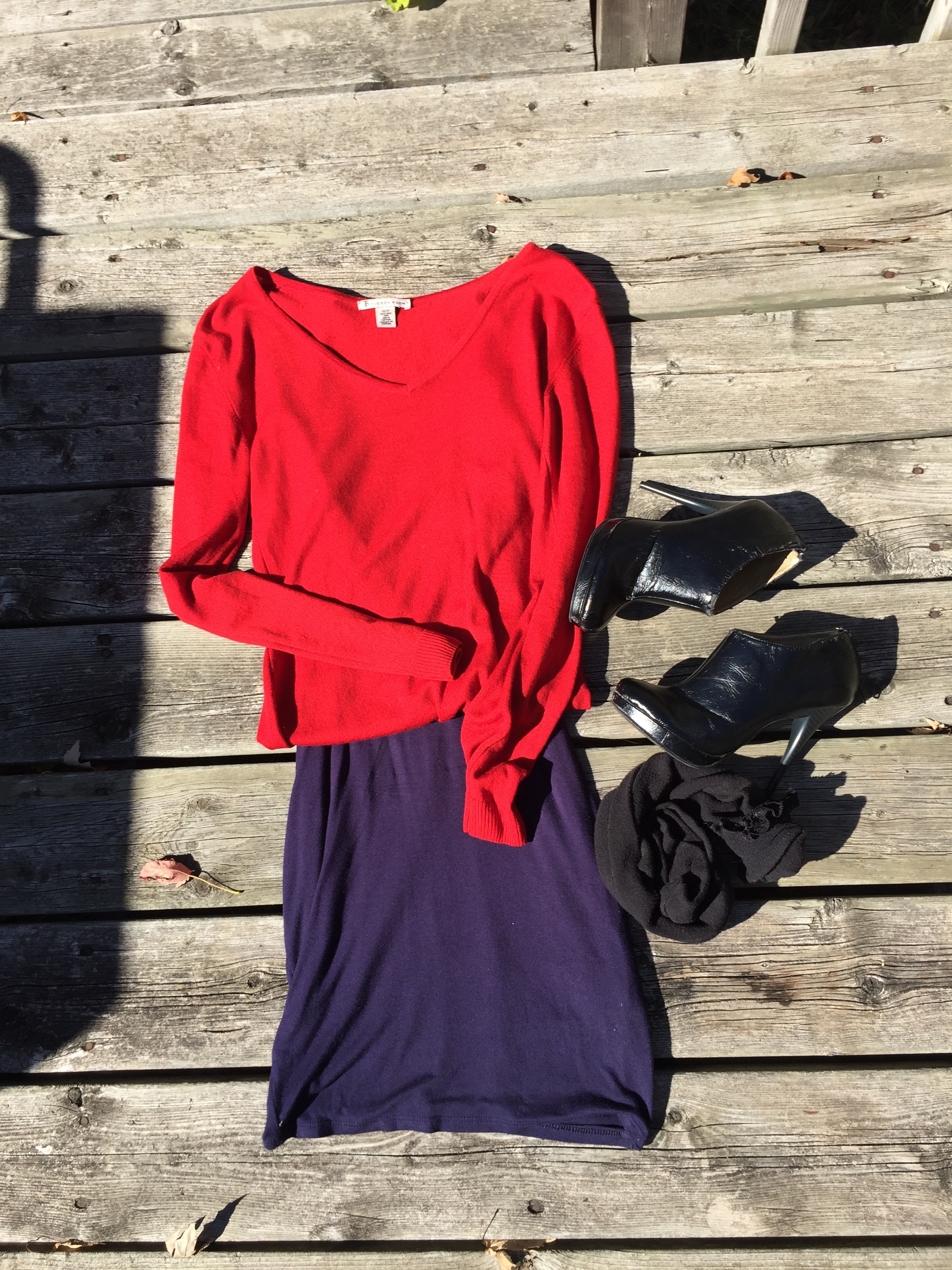 Navy dress paired with a red cashmere cardigan, knee high socks and black booties