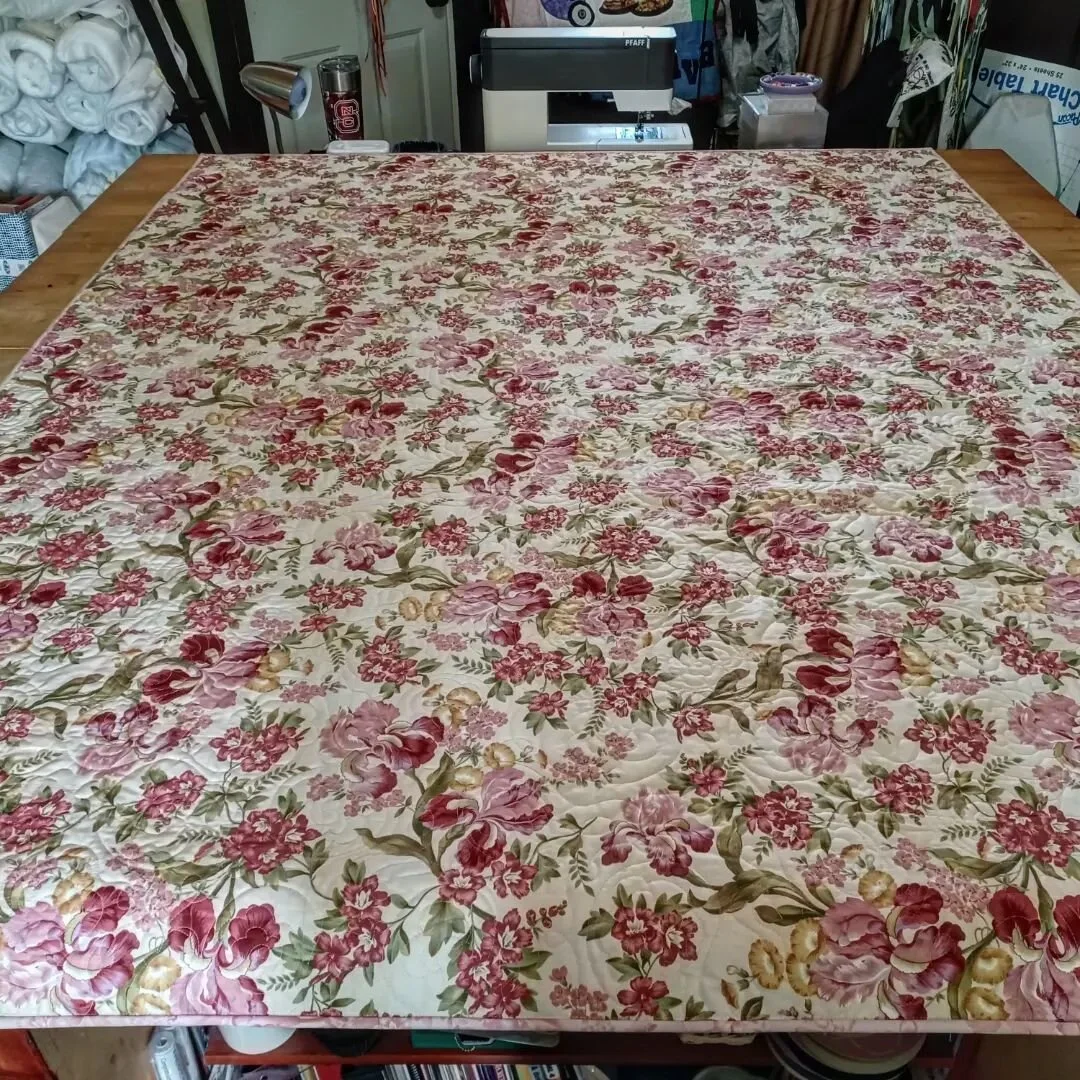 I had the pleasure of finishing this quilt for a client. Her mother in law started it. She completed all the blocks, and I constructed the sashing and pieced the top with the border. I quilted and bound the quilt for her, too.  I also matched the pat