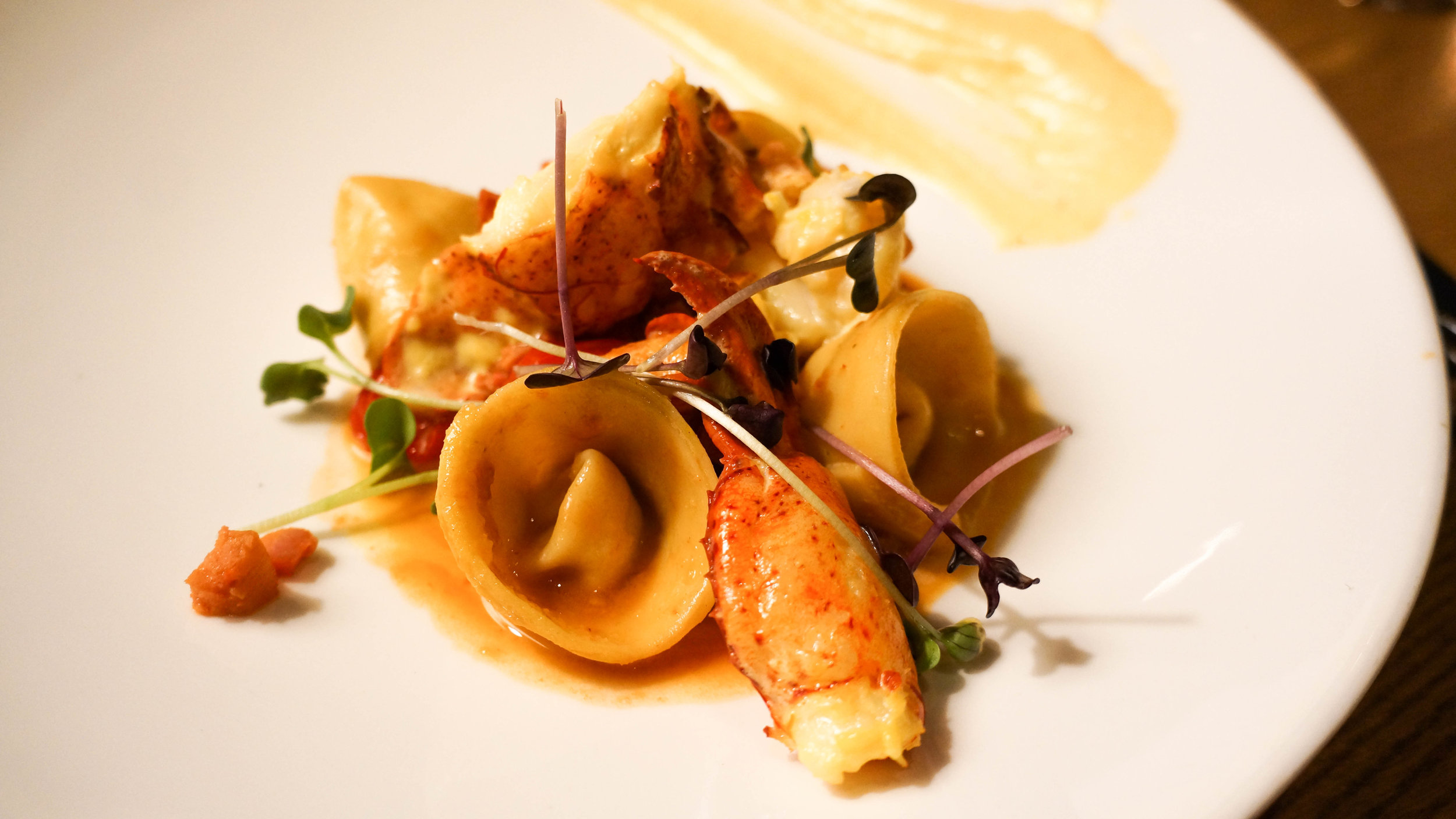 Saffron-butter poached lobster, chorizo, fennel, and orange tortellini in a bouillabaisse broth, rouille.