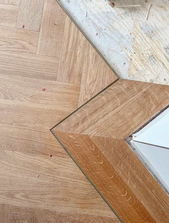 home renovations in Toronto - install herringbone flooring with brass inlay and border from chestnut flooring in natural oak finish-2.jpg