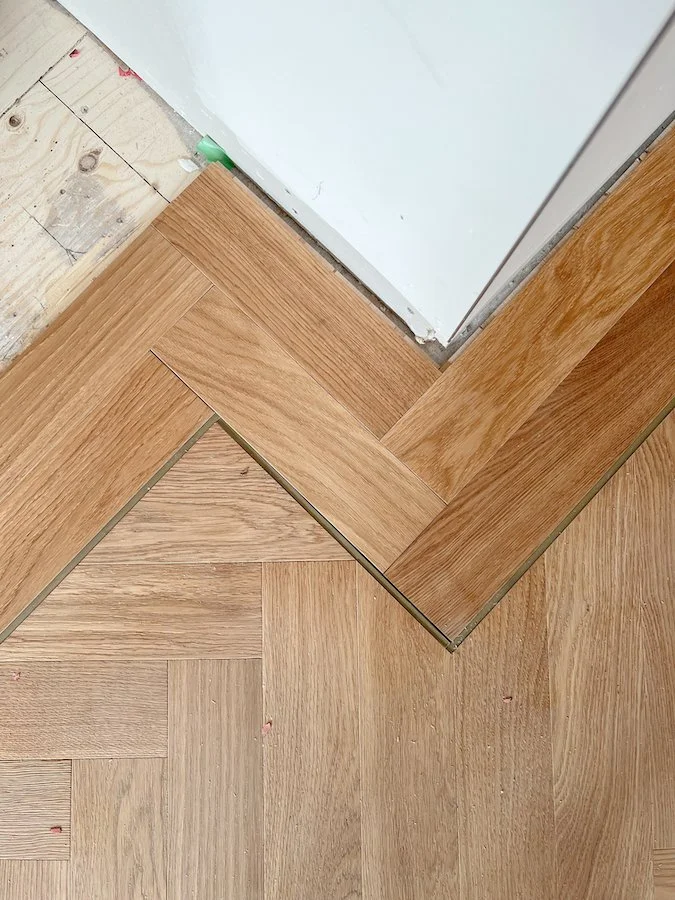 home renovations in Toronto - install herringbone flooring with brass inlay and border from chestnut flooring in natural oak finish-3.jpg