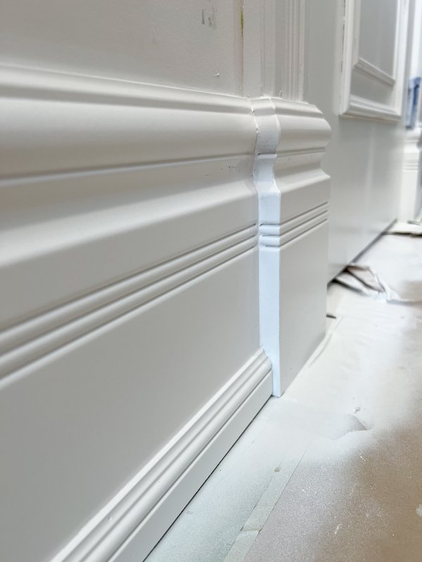 Toronto Home renovations - victorian style home - spray gun painting victorian baseboards and fine carpentry_.jpg