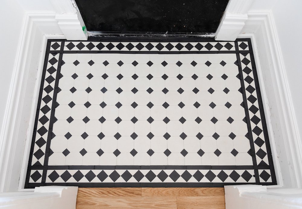 modern victorian house - home renovations toronto - foyer tiles - winckelman tiles black and white victorian tiles with boarder design.jpg