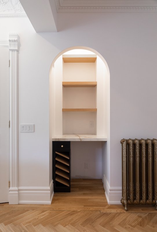 home renovations toronto - victorian house renovations - arched bar and coffee nook after install - wine cabinet with fridge and calacatta porcelain countertip and navy blue cabinet - herringbone floors-4.jpg