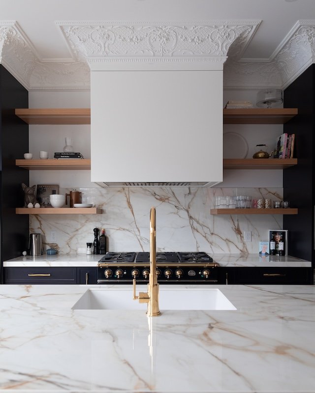 Toronto home renovations - renovating a victorian home - navy kitchen renovations - calacatta gold porcelain countertop with floating shelves and crown mouldings and brass kitchen faucet - rohl faucets.jpg