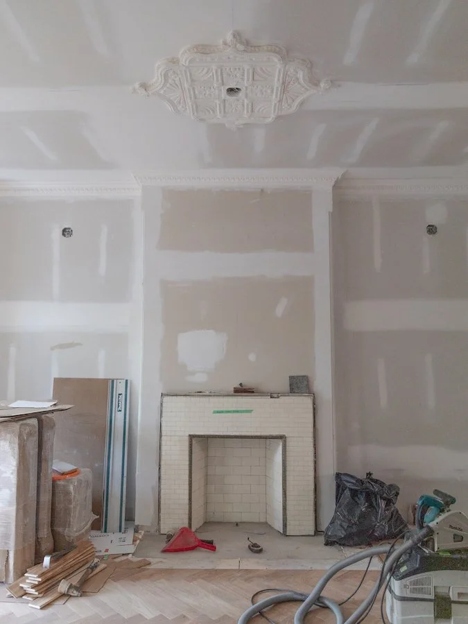 home renovations in Toronto - install herringbone flooring with brass inlay from chestnut flooring - fireplace and ceiling medallion with egg and dart crown mouldings
