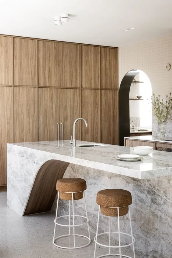 kitchen trends 2024 - natural wood kitchen cabinets with marble island - credit unios