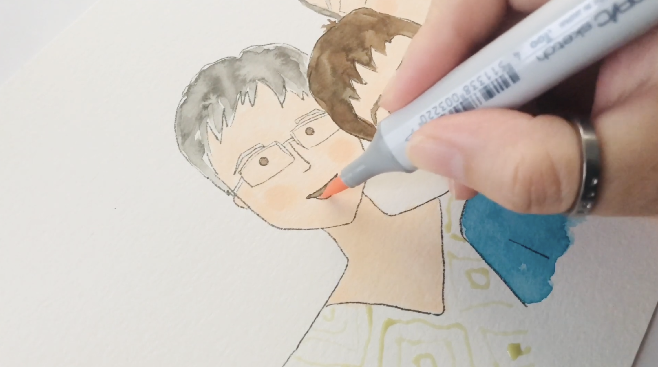 Adding color to the face using Copic alcohol markers on a custom portrait, showing layered color and texture on watercolor paper.
