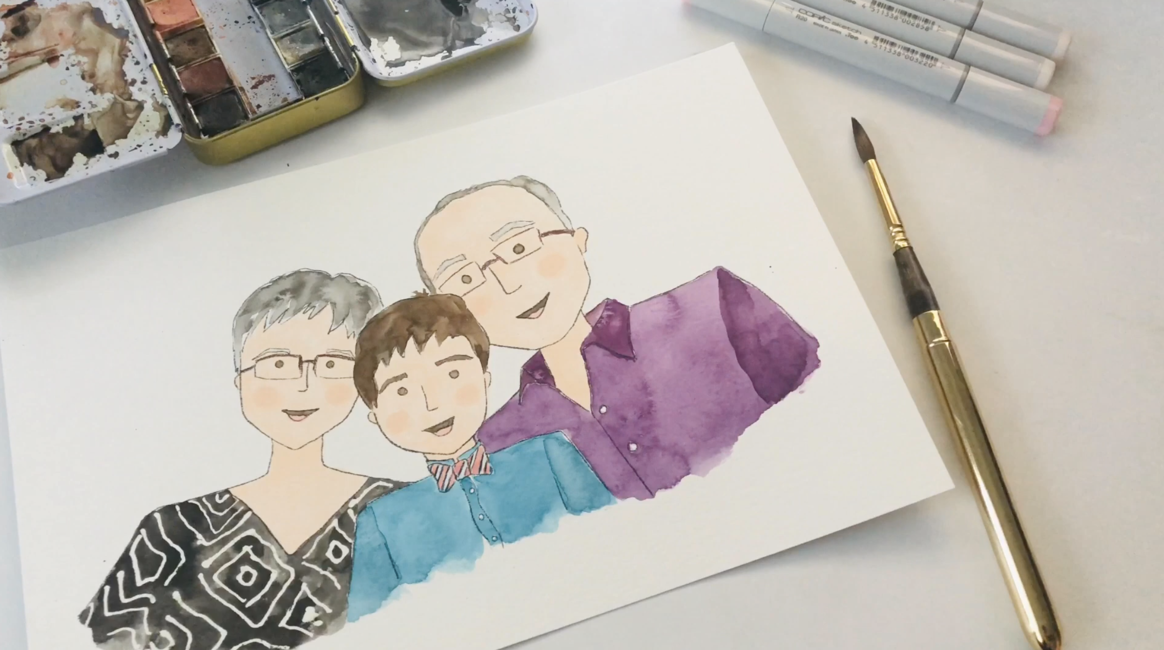 Watercolor and colored pencil portrait in progress on Canson XL watercolor paper, with paint palette, brushes, and markers visible during the Happy B Portraits process.