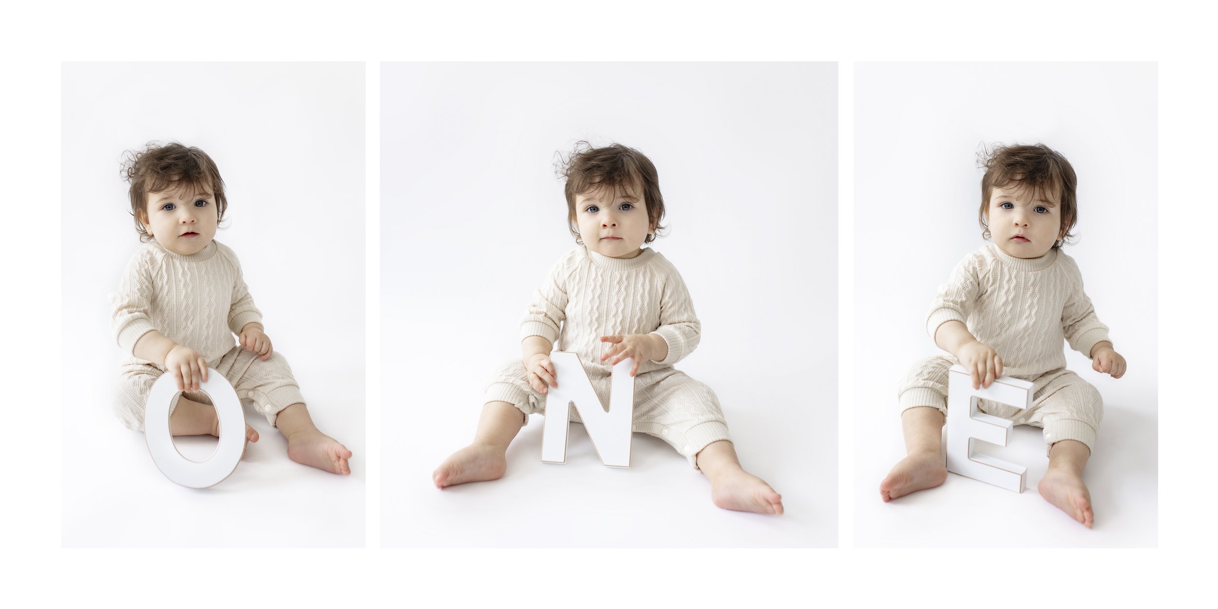 First birthday milestone photo featuring a one year old holding letters spelling "one." Captured in bright, minimal studio setting.
