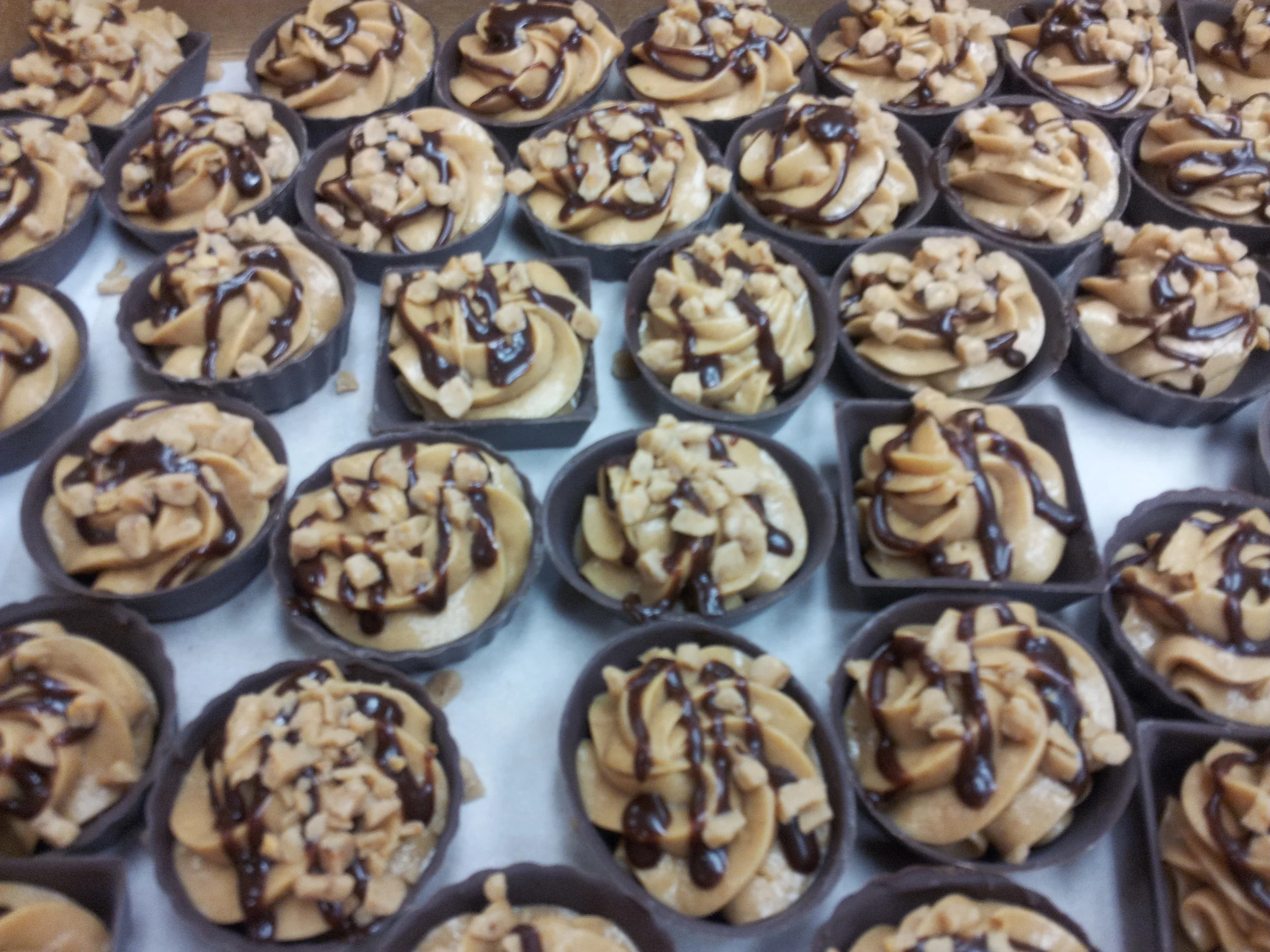 Peanut butter mousse chocolate cups topped with heath crunch