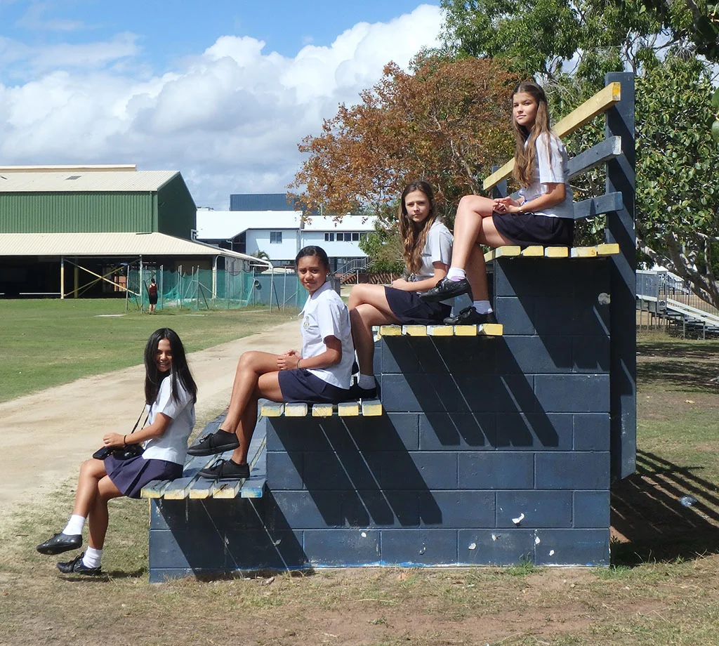 Bowen State High School students (com)posed on the school grounds.