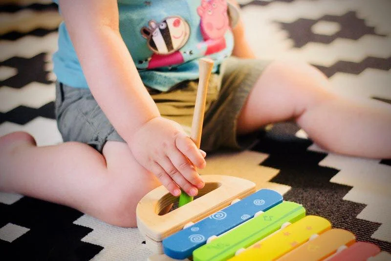baby with music toy.jpg