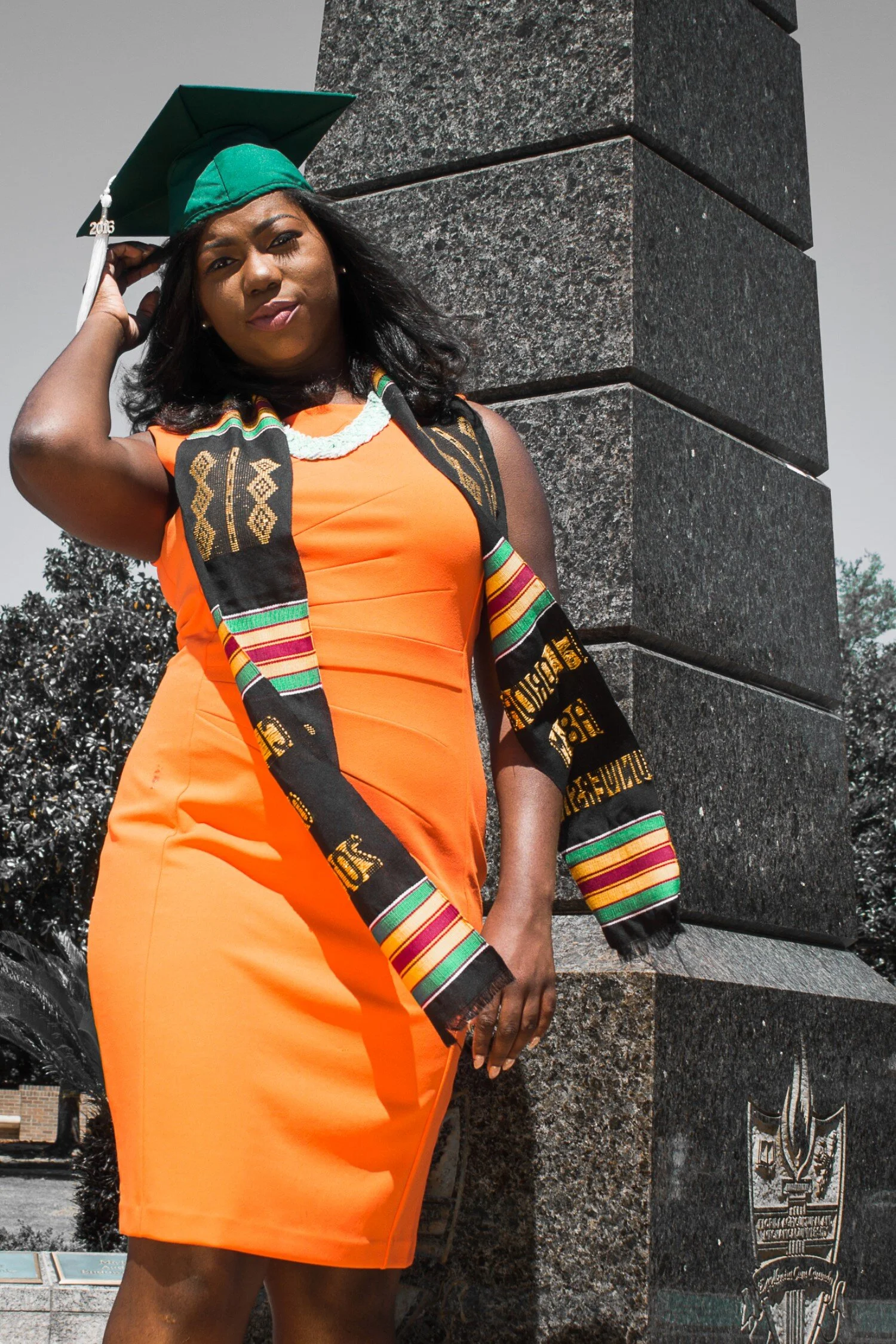 FAMU graduate Shaperlya in an orange dress at the Eternal Flame