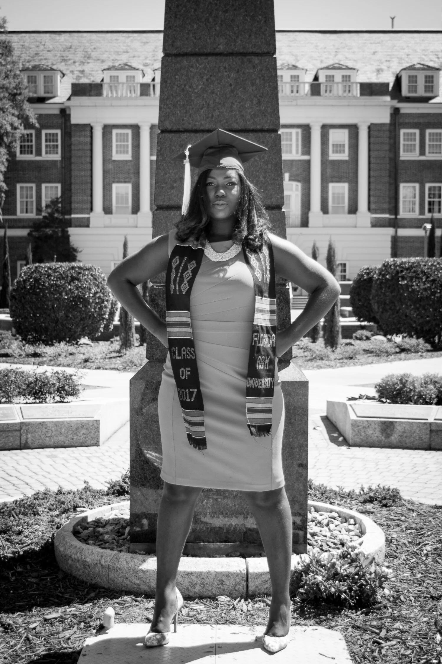  Black and white photo of FAMU graduate Shaperlya in an orange dress at the Eternal Flame 