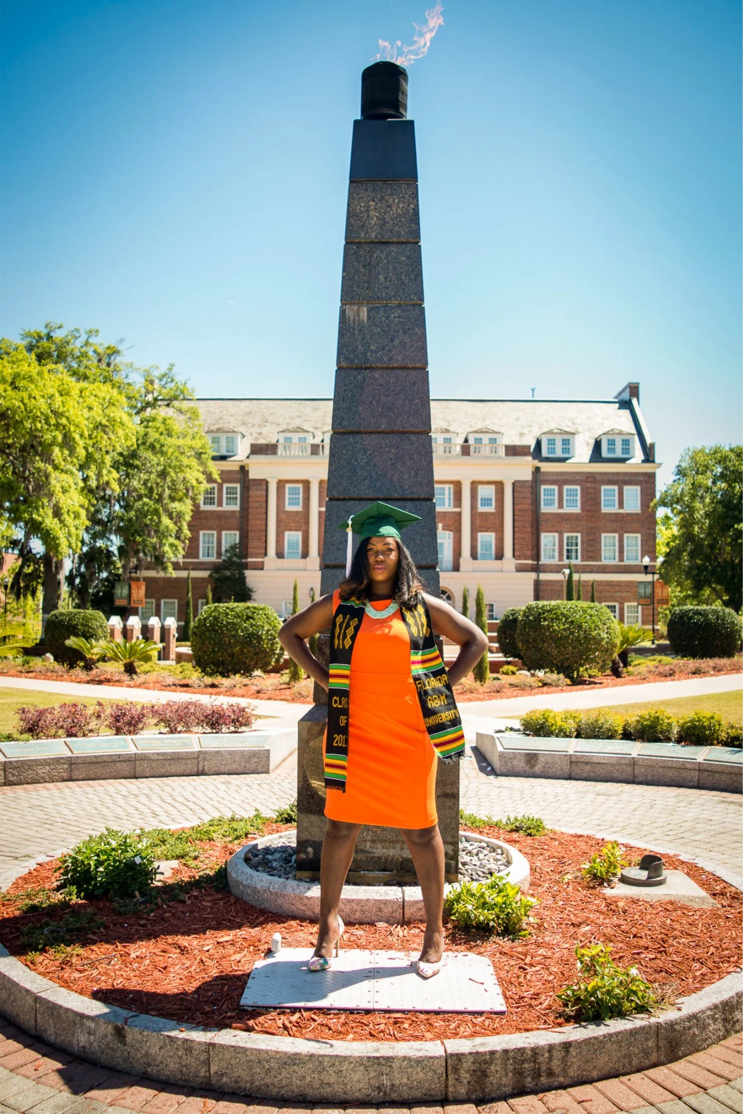  FAMU graduate Shaperlya in an orange dress at the Eternal Flame 