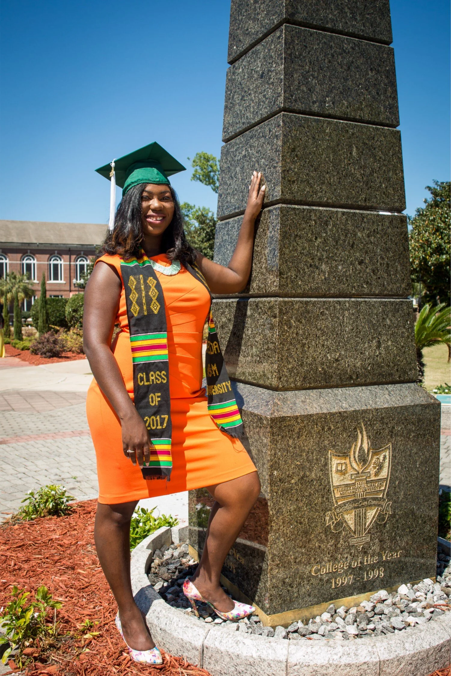  FAMU graduate Shaperlya in an orange dress at the Eternal Flame 