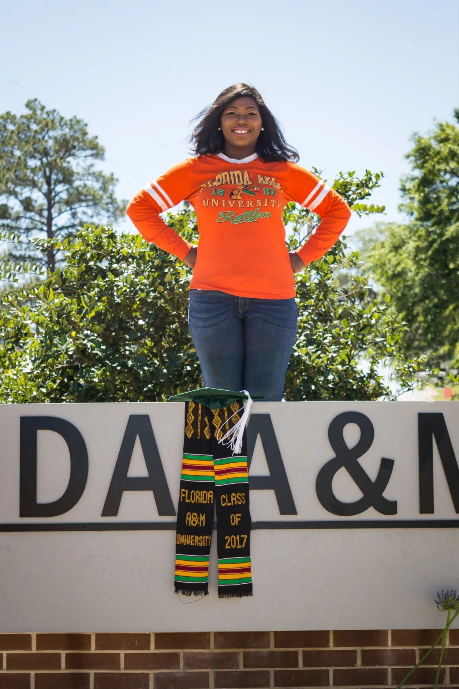  Graduate Shaperlya posing on new FAMU roundabout in a casual university tshirt and jeans. 